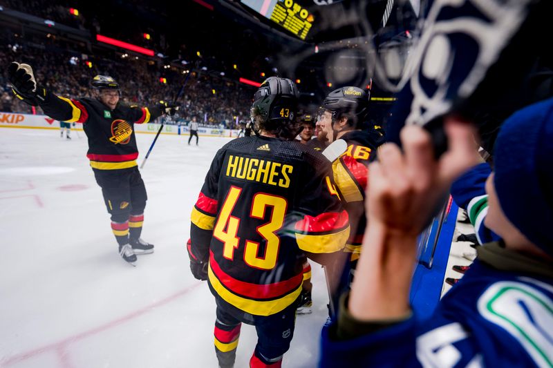 Dec 23, 2023; Vancouver, British Columbia, CAN; Vancouver Canucks defenseman Quinn Hughes (43) and forward Andrei Kuzmenko (96) celebrate Kuzmenko   s first goal of the game against the San Jose Sharks in the first period at Rogers Arena. Mandatory Credit: Bob Frid-USA TODAY Sports