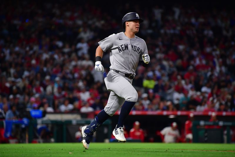 May 27, 2025; Anaheim, California, USA; New York Yankees shortstop Anthony Volpe (11) runs after hitting an RBI single against the Los Angeles Angels during the sixth inning at Angel Stadium. Mandatory Credit: Gary A. Vasquez-Imagn Images