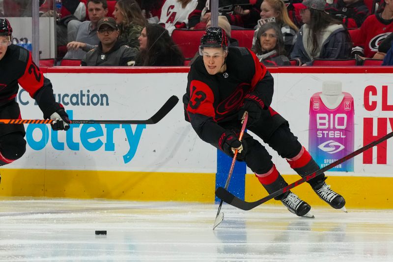 Mar 11, 2023; Raleigh, North Carolina, USA; Carolina Hurricanes right wing Jesse Puljujarvi (13) skates with the puck against the Vegas Golden Knights during the third period at PNC Arena. Mandatory Credit: James Guillory-USA TODAY Sports