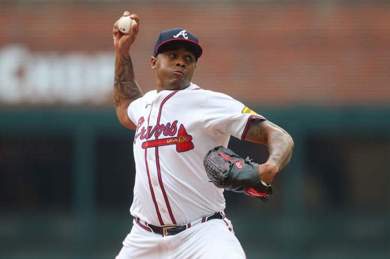 Sep 30, 2024; Atlanta, Georgia, USA; Atlanta Braves relief pitcher Raisel Iglesias (26) throws against the New York Mets in the eighth inning at Truist Park. Mandatory Credit: Brett Davis-Imagn Images
