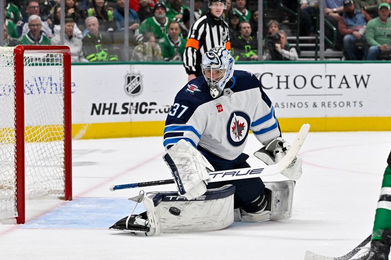 Feb 29, 2024; Dallas, Texas, USA; Winnipeg Jets goaltender Connor Hellebuyck (37) makes a pad save on a Dallas Stars shot during the second period at the American Airlines Center. Mandatory Credit: Jerome Miron-USA TODAY Sports