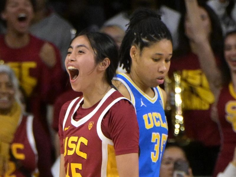 Jan 14, 2024; Los Angeles, California, USA; USC Trojans guard Kayla Padilla (45) celebrates as UCLA Bruins guard Camryn Brown (35) walks off the court at the end of the game at Galen Center. Mandatory Credit: Jayne Kamin-Oncea-USA TODAY Sports