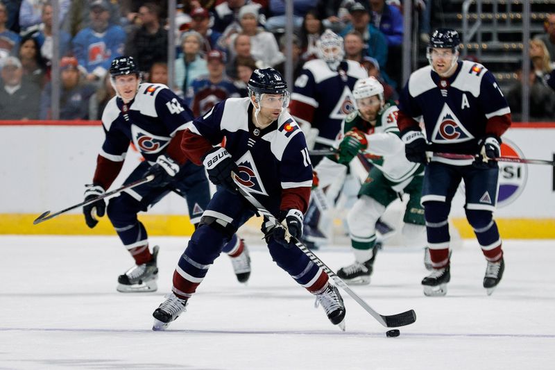 Apr 9, 2024; Denver, Colorado, USA; Colorado Avalanche center Andrew Cogliano (11) controls the puck ahead of defenseman Josh Manson (42) and defenseman Devon Toews (7) in the second period against the Minnesota Wild at Ball Arena. Mandatory Credit: Isaiah J. Downing-USA TODAY Sports