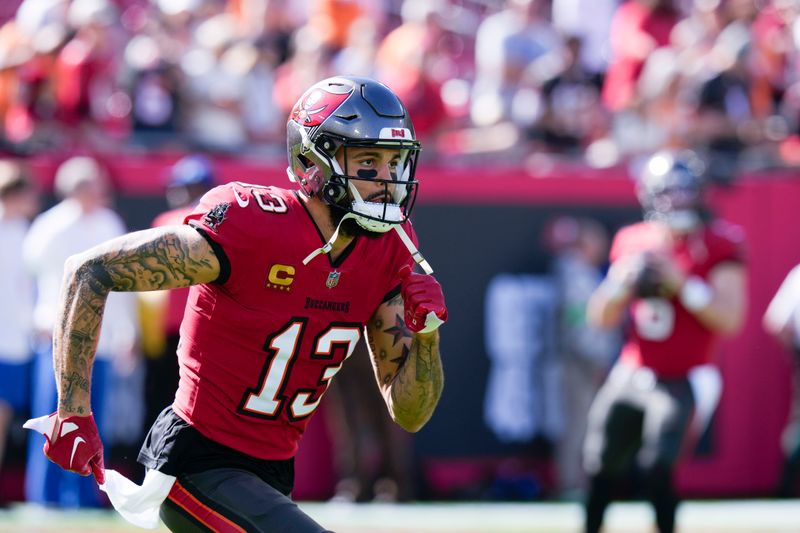 Tampa Bay Buccaneers wide receiver Mike Evans (13) warms up before an NFL football game against the New Orleans Saints in Tampa, Fla., Sunday, Dec. 31, 2023. (AP Photo/Chris O'Meara)