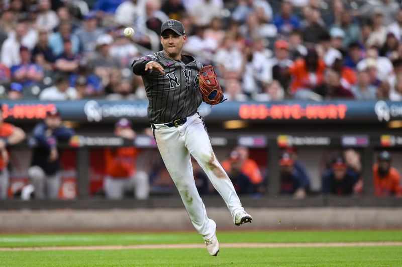 Jun 29, 2024; New York City, New York, USA; New York Mets second baseman Jose Iglesias (11) fields a bunt and throws to first base for an out during the ninth inning against the Houston Astros at Citi Field. Mandatory Credit: John Jones-USA TODAY Sports