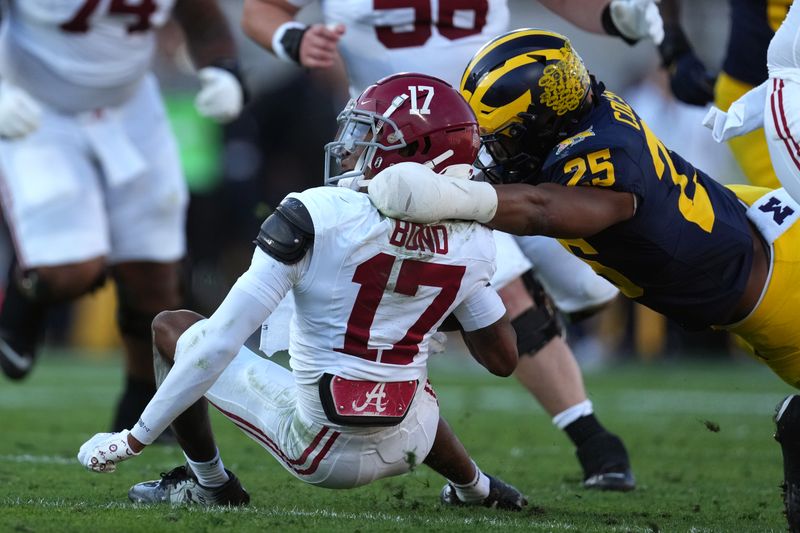 Jan 1, 2024; Pasadena, CA, USA; Alabama Crimson Tide wide receiver Isaiah Bond (17) is tackled by Michigan Wolverines linebacker Junior Colson (25) during the first half in the 2024 Rose Bowl college football playoff semifinal game at Rose Bowl. Mandatory Credit: Kirby Lee-USA TODAY Sports