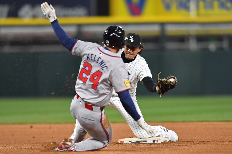 Apr 2, 2024; Chicago, Illinois, USA; Chicago White Sox second baseman Nicky Lopez (8) attempts to tag out Atlanta Braves left fielder Jarred Kelenic (24) during the eighth inning at Guaranteed Rate Field. Mandatory Credit: Patrick Gorski-USA TODAY Sports