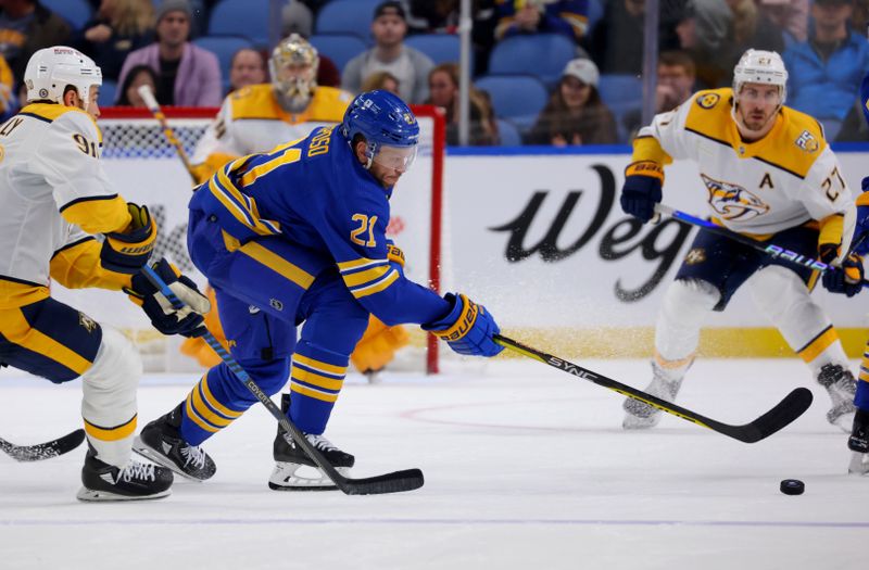 Dec 3, 2023; Buffalo, New York, USA;  Buffalo Sabres right wing Kyle Okposo (21) looks to control the puck during the third period against the Nashville Predators at KeyBank Center. Mandatory Credit: Timothy T. Ludwig-USA TODAY Sports