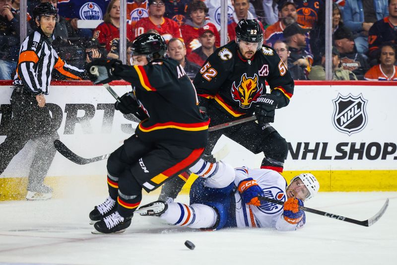 Apr 6, 2024; Calgary, Alberta, CAN; Edmonton Oilers center Connor McDavid (97) and Calgary Flames defenseman MacKenzie Weegar (52) battles for the puck during the third period at Scotiabank Saddledome. Mandatory Credit: Sergei Belski-USA TODAY Sports