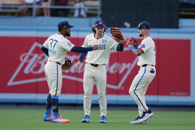 Jul 6, 2024; Los Angeles, California, USA; Los Angeles Dodgers left fielder Teoscar Hernandez (37), center fielder James Outman (33) and right fielder Andy Pages (44) celebrate after the game against the Milwaukee Brewers at Dodger Stadium. Mandatory Credit: Kirby Lee-USA TODAY Sports