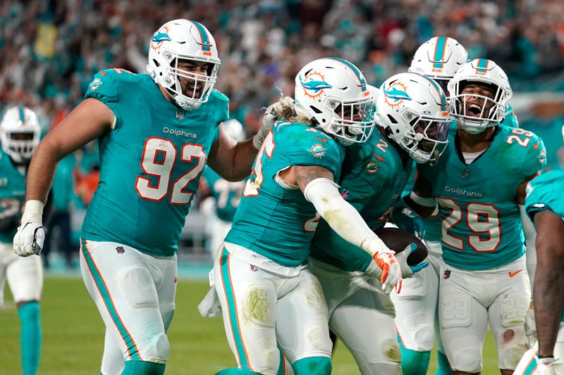 Miami Dolphins linebacker Bradley Chubb (2) celebrates with defensive tackle Zach Sieler (92), linebacker Duke Riley (45) and safety Brandon Jones (29) after recovering a fumble during the second half of an NFL football game against the Tennessee Titans, Monday, Dec. 11, 2023, in Miami. (AP Photo/Lynne Sladky)