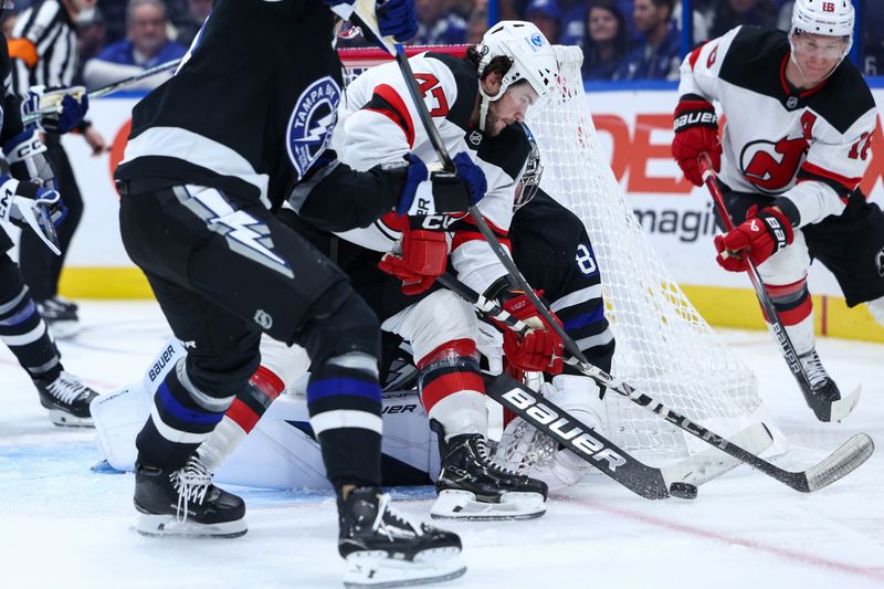 Nov 16, 2024; Tampa, Florida, USA; Tampa Bay Lightning goaltender Andrei Vasilevskiy (88) makes a save on a shot from New Jersey Devils center Paul Cotter (47) in the second period at Amalie Arena. Mandatory Credit: Nathan Ray Seebeck-Imagn Images