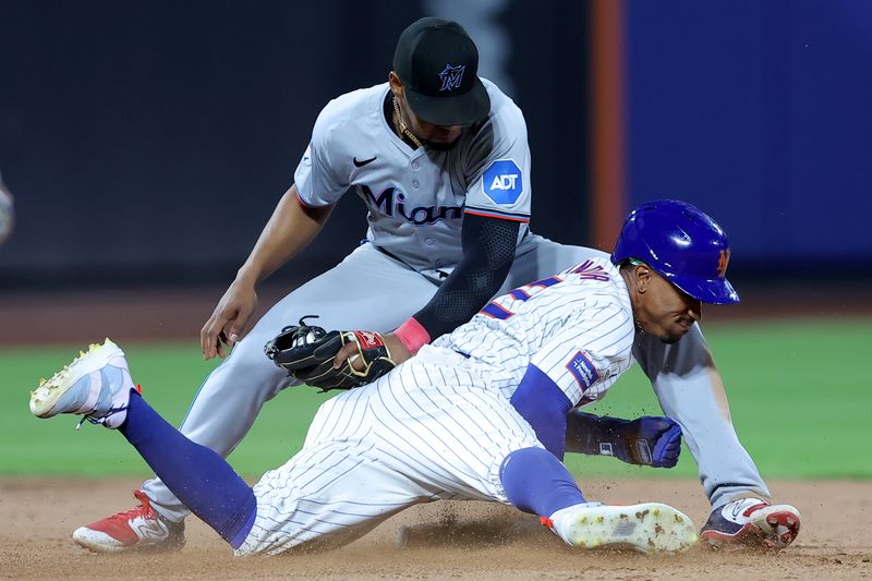 Jun 13, 2024; New York City, New York, USA; New York Mets shortstop Francisco Lindor (12) steals second base ahead of the tag by Miami Marlins second baseman Otto Lopez (61) during the ninth inning at Citi Field. Mandatory Credit: Brad Penner-USA TODAY Sports