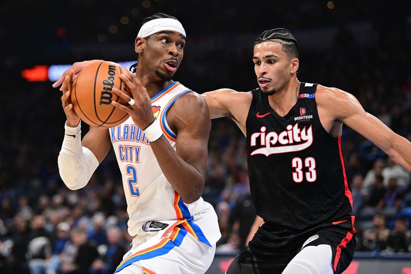 OKLAHOMA CITY, OKLAHOMA - NOVEMBER 20: Shai Gilgeous-Alexander #2 of the Oklahoma City Thunder handles the ball while being defended by Toumani Camara #33 of the Portland Trail Blazers during the first half at Paycom Center on November 20, 2024 in Oklahoma City, Oklahoma. NOTE TO USER: User expressly acknowledges and agrees that, by downloading and or using this photograph, User is consenting to the terms and conditions of the Getty Images License Agreement. (Photo by Joshua Gateley/Getty Images)