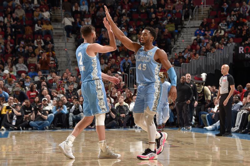 CLEVELAND, OH - DECEMBER 8:  Ty Jerome #2 and Donovan Mitchell #45 of the Cleveland Cavaliers high five during the game against the Denver Nuggets on December 5, 2024 at Rocket Mortgage FieldHouse in Cleveland, Ohio. NOTE TO USER: User expressly acknowledges and agrees that, by downloading and/or using this Photograph, user is consenting to the terms and conditions of the Getty Images License Agreement. Mandatory Copyright Notice: Copyright 2024 NBAE (Photo by David Liam Kyle/NBAE via Getty Images)