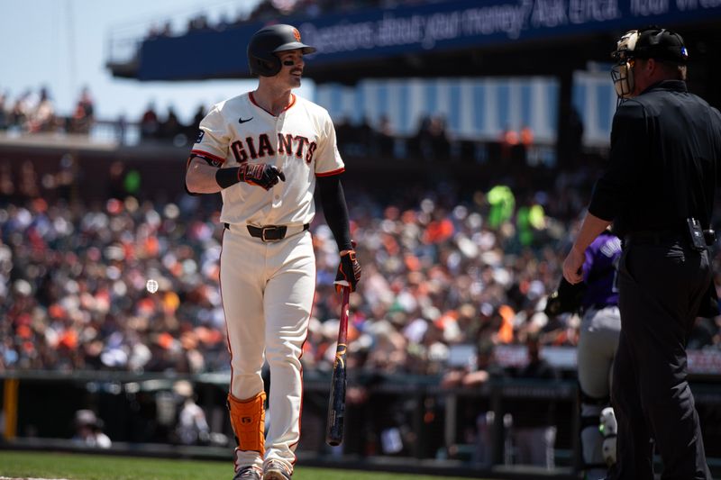 May 18, 2024; San Francisco, California, USA; San Francisco Giants right fielder Mike Yastrzemski (5) confers with home plate umpire Sean Barber after being called out on strikes against the Colorado Rockies during the third inning at Oracle Park. Mandatory Credit: D. Ross Cameron-USA TODAY Sports