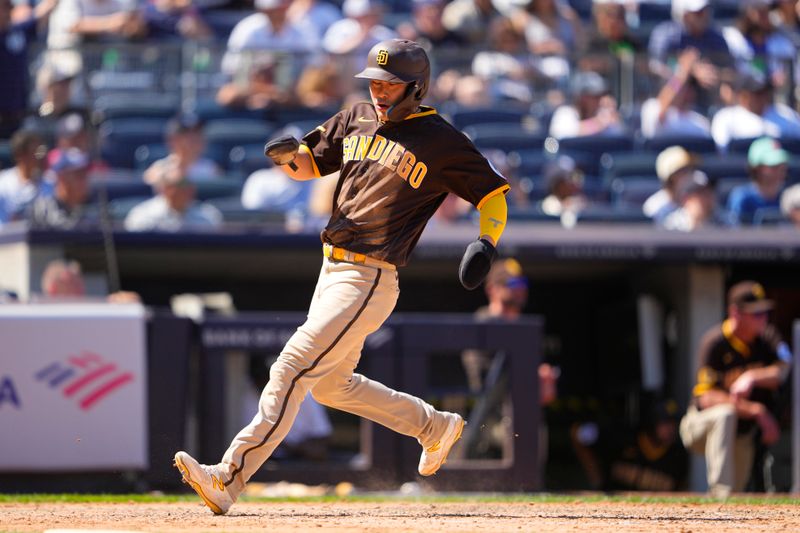 May 28, 2023; Bronx, New York, USA; San Diego Padres third baseman Ha-Seong Kim (7) scores a run on San Diego Padres right fielder Jose Azocar (28) (not pictured) RBI single against the New York Yankees during the seventh inning at Yankee Stadium. Mandatory Credit: Gregory Fisher-USA TODAY Sports