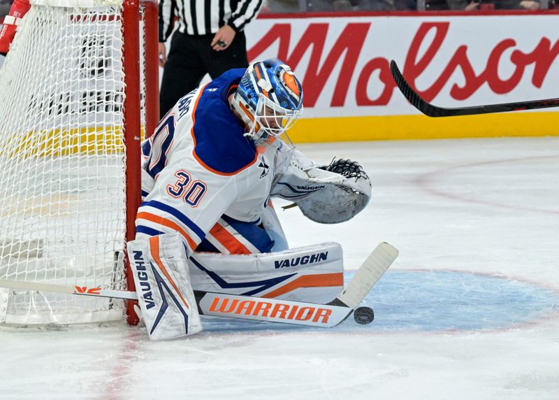 Nov 18, 2024; Montreal, Quebec, CAN; Edmonton Oilers goalie Calvin Pickard (30) makes a save during the second period of the game against the Montreal Canadiens at the Bell Centre. Mandatory Credit: Eric Bolte-Imagn Images