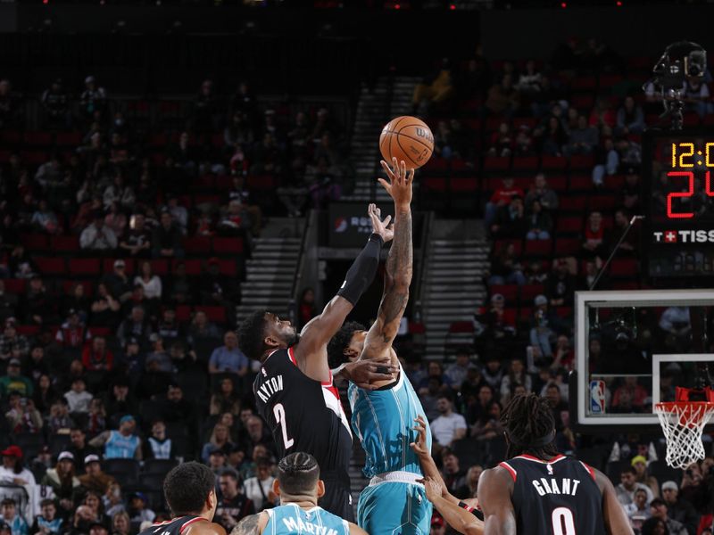 PORTLAND, OR - FEBRUARY 25: Opening tip-off between Nick Richards #4 of the Charlotte Hornets & Deandre Ayton #2 of the Portland Trail Blazers  on February 25, 2024 at the Moda Center Arena in Portland, Oregon. NOTE TO USER: User expressly acknowledges and agrees that, by downloading and or using this photograph, user is consenting to the terms and conditions of the Getty Images License Agreement. Mandatory Copyright Notice: Copyright 2024 NBAE (Photo by Cameron Browne/NBAE via Getty Images)