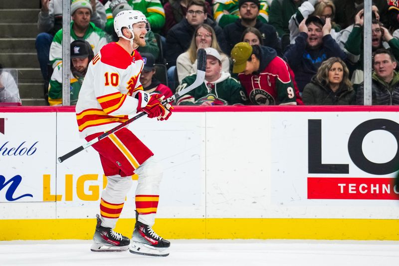 Jan 2, 2024; Saint Paul, Minnesota, USA; Calgary Flames center Jonathan Huberdeau (10) celebrates his goal during the first period against the Minnesota Wild at Xcel Energy Center. Mandatory Credit: Brace Hemmelgarn-USA TODAY Sports