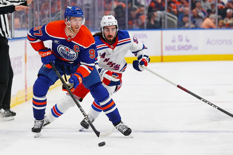 Nov 23, 2024; Edmonton, Alberta, CAN; Edmonton Oilers forward Connor McDavid (97) looks to make a pass in front of New York Rangers forward Mika Zibanejad (93) during the third period at Rogers Place. Mandatory Credit: Perry Nelson-Imagn Images