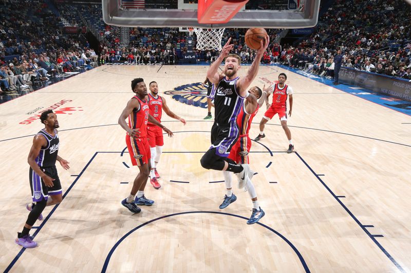 NEW ORLEANS, LA - DECEMBER 12: Domantas Sabonis #11 of the Sacramento Kings drives to the basket during the game against the New Orleans Pelicans on December 12, 2024 at the Smoothie King Center in New Orleans, Louisiana. NOTE TO USER: User expressly acknowledges and agrees that, by downloading and or using this Photograph, user is consenting to the terms and conditions of the Getty Images License Agreement. Mandatory Copyright Notice: Copyright 2024 NBAE (Photo by Layne Murdoch Jr./NBAE via Getty Images)