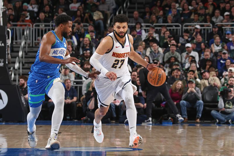 MILWAUKEE, WI - FEBRUARY 12: Jamal Murray #27 of the Denver Nuggets brings the ball up court during the game against the Milwaukee Bucks on February 12, 2024 at the Fiserv Forum Center in Milwaukee, Wisconsin. NOTE TO USER: User expressly acknowledges and agrees that, by downloading and or using this Photograph, user is consenting to the terms and conditions of the Getty Images License Agreement. Mandatory Copyright Notice: Copyright 2024 NBAE (Photo by Gary Dineen/NBAE via Getty Images).