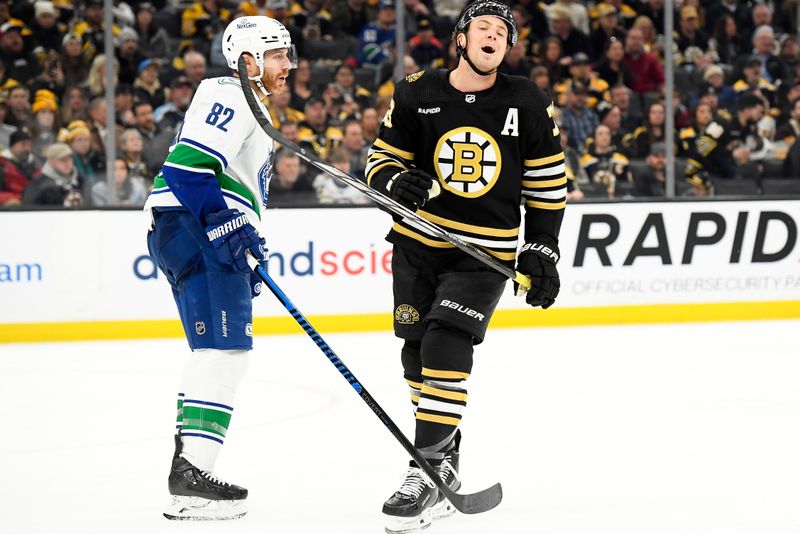 Feb 8, 2024; Boston, Massachusetts, USA; Boston Bruins defenseman Charlie McAvoy (73) reacts in front of Vancouver Canucks defenseman Ian Cole (82) after an off- sides call during the third period at TD Garden. Mandatory Credit: Bob DeChiara-USA TODAY Sports