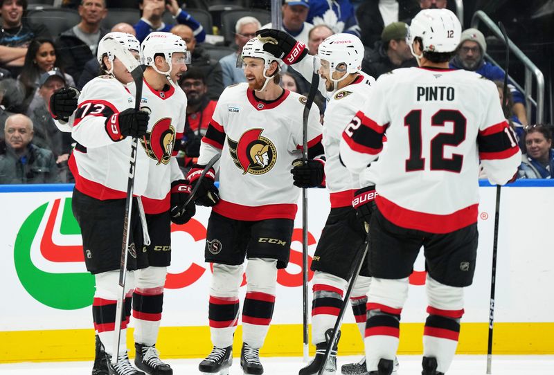 Nov 12, 2024; Toronto, Ontario, CAN; Ottawa Senators right wing Michael Amadio (22) scores a goal and celebrates with left wing Noah Gregor (73) and teammates against the Toronto Maple Leafs during the second period at Scotiabank Arena. Mandatory Credit: Nick Turchiaro-Imagn Images