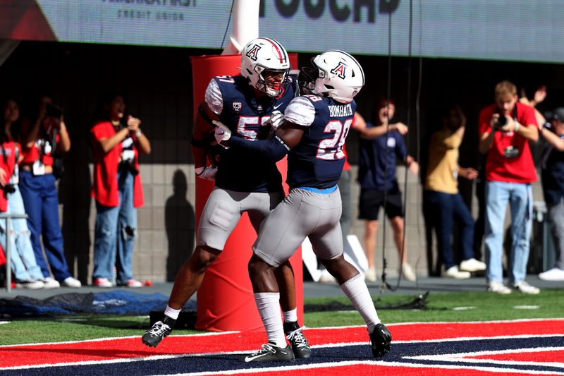 Nov 18, 2023; Tucson, Arizona, USA; Arizona Wildcats linebacker Anthony Ward (57) celebrates with running back Nazar Bombata (28) after a returned blocked punt for a touchdown against the Utah Utes during the first half at Arizona Stadium. Mandatory Credit: Zachary BonDurant-USA TODAY Sports