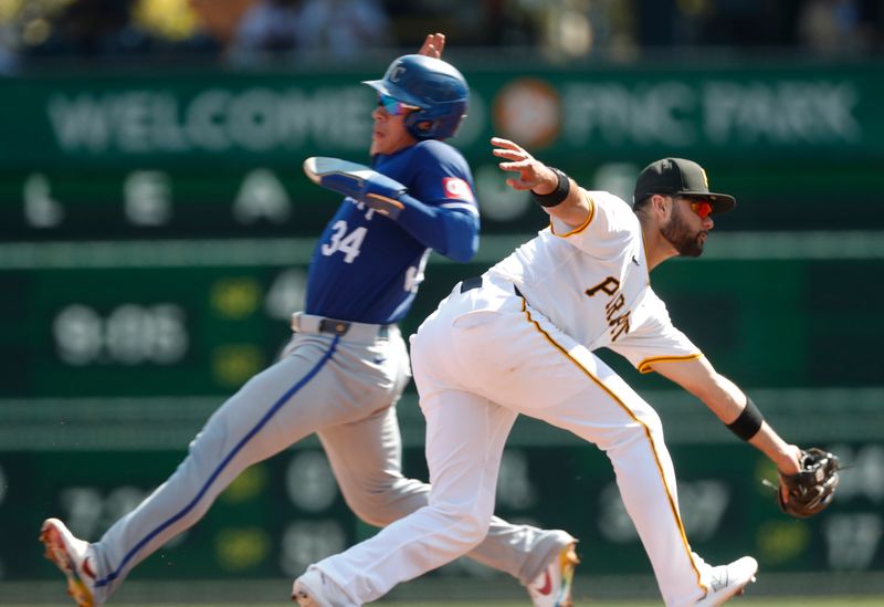 Sep 14, 2024; Pittsburgh, Pennsylvania, USA;  Kansas City Royals catcher Freddy Fermin (34) steals second base as Pittsburgh Pirates shortstop Isiah Kiner-Falefa (right) takes a wide throw during the sixth inning at PNC Park. Mandatory Credit: Charles LeClaire-Imagn Images