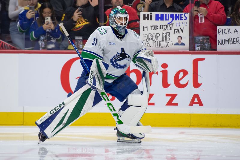 Nov 23, 2024; Ottawa, Ontario, CAN; Vancouver Canucks goalie Arturs Silovs (31) stretches during warmup prior to game against the Ottawa Senators at the Canadian Tire Centre. Mandatory Credit: Marc DesRosiers-Imagn Images