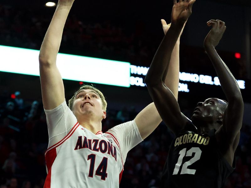 Jan 4, 2024; Tucson, Arizona, USA; Arizona Wildcats center Motiejus Krivas (14) shoots a basket Colorado Buffaloes forward Bangot Dak (12) during the second half at McKale Center. Mandatory Credit: Zachary BonDurant-USA TODAY Sports