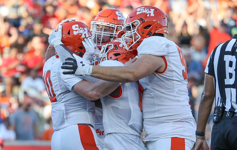 Sep 23, 2023; Houston, Texas, USA; Sam Houston State Bearkats quarterback Trapper Pannell (10) celebrates with teammates after scoring a touchdown during the first quarter against the Houston Cougars at TDECU Stadium. Mandatory Credit: Troy Taormina-USA TODAY Sports