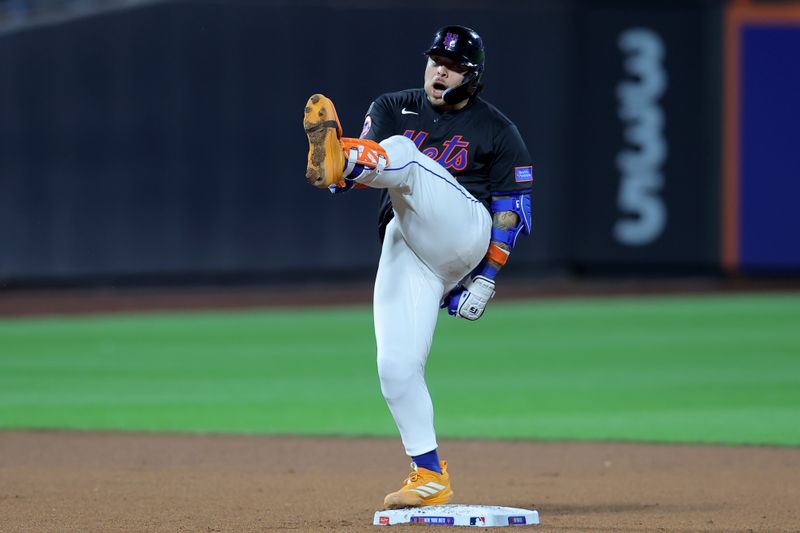 Sep 19, 2025; New York City, New York, USA; New York Mets catcher Francisco Alvarez (4) reacts after hitting a two run double against the Washington Nationals during the fourth inning at Citi Field. Mandatory Credit: Brad Penner-Imagn Images