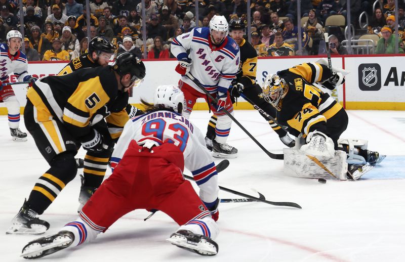 Jan 31, 2026; Pittsburgh, Pennsylvania, USA;  Pittsburgh Penguins goaltender Stuart Skinner (74) defends the net against New York Rangers center J.T. Miller (8) and center Mika Zibanejad (93) during the second period at PPG Paints Arena. Mandatory Credit: Charles LeClaire-Imagn Images