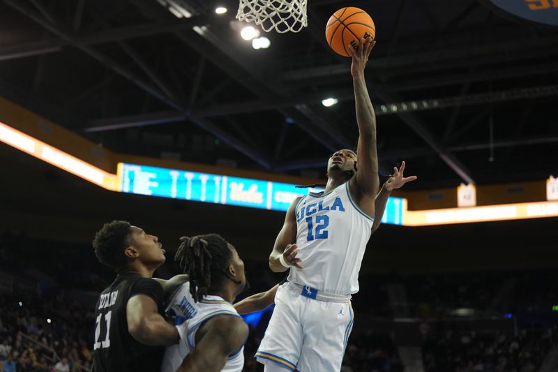 Dec 19, 2023; Los Angeles, California, USA; UCLA Bruins guard Sebastian Mack (12) shoots the ball against the Cal State Northridge Matadors in the second half at Pauley Pavilion presented by Wescom. CSUN defeated UCLA 76-72. Mandatory Credit: Kirby Lee-USA TODAY Sports