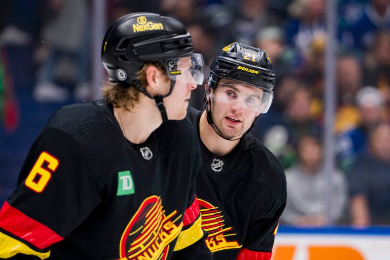 Dec 7, 2023; Vancouver, British Columbia, CAN; Vancouver Canucks forward Nils Hoglander (21) discusses face off stratedgy with forward Brock Boeser (6) during a stop in play against the Minnesota Wild in the second period at Rogers Arena. Mandatory Credit: Bob Frid-USA TODAY Sports