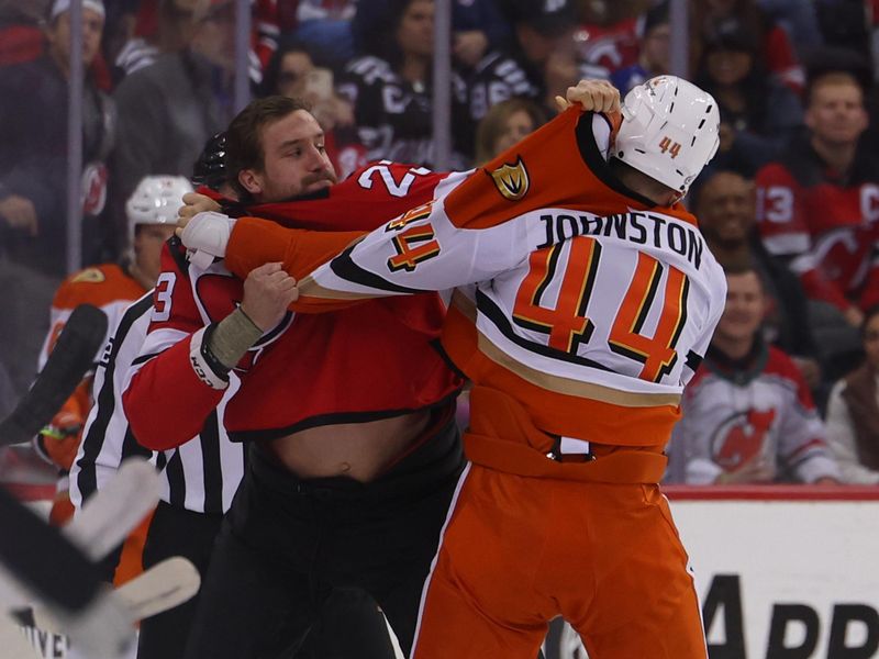 Oct 27, 2024; Newark, New Jersey, USA; Anaheim Ducks left wing Ross Johnston (44) and New Jersey Devils left wing Kurtis MacDermid (23) fight during the first period at Prudential Center. Mandatory Credit: Ed Mulholland-Imagn Images