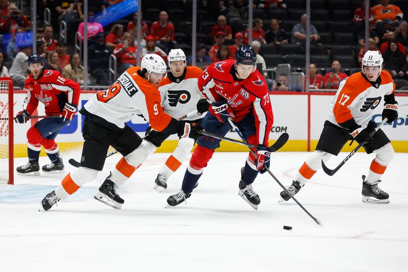 Sep 22, 2024; Washington, District of Columbia, USA; Washington Capitals forward Eriks Mateiko (73) and Philadelphia Flyers defenseman Jamie Drysdale (9) battle for the puck in the first period at Capital One Arena. Mandatory Credit: Geoff Burke-Imagn Images