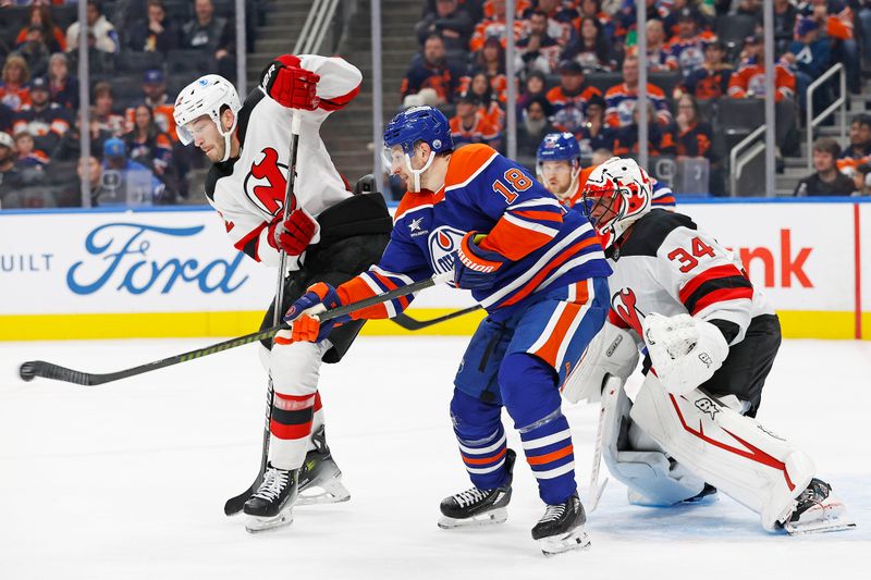 Nov 4, 2024; Edmonton, Alberta, CAN; Edmonton Oilers forward Zach Hyman (18) deflects a shot on New Jersey Devils goaltender Jake Allen (34) during the third period at Rogers Place. Mandatory Credit: Perry Nelson-Imagn Images