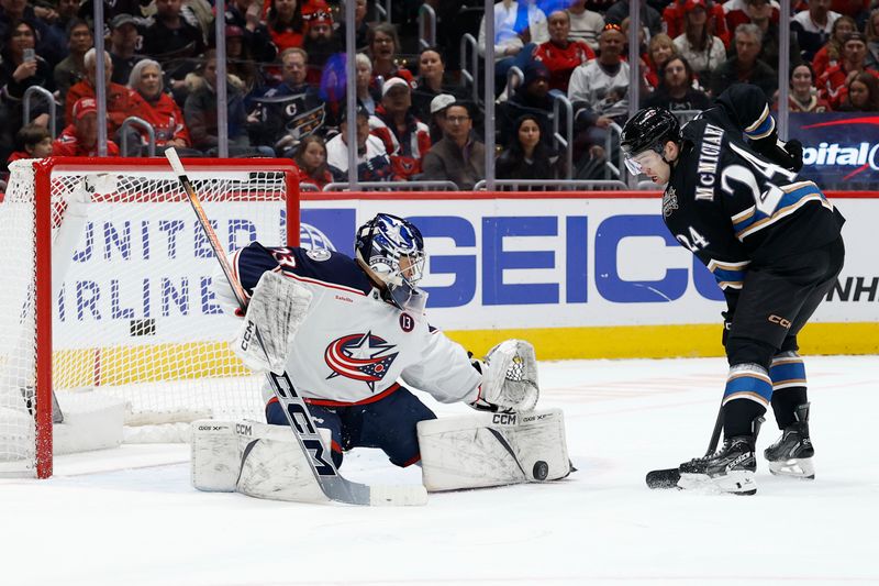 Apr 13, 2025; Washington, District of Columbia, USA; Columbus Blue Jackets goaltender Jet Greaves (73) makes a save on Washington Capitals center Connor McMichael (24) in the first period at Capital One Arena. Mandatory Credit: Geoff Burke-Imagn Images