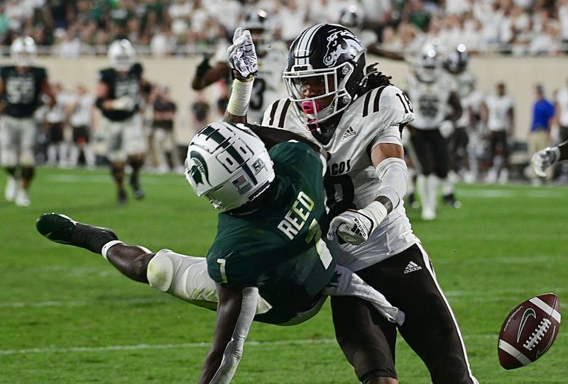 Sep 2, 2022; East Lansing, Michigan, USA; Michigan State Spartans wide receiver Jayden Reed (1) draws a pass interference call against Western Michigan Broncos cornerback Keni-H Lovely (18) at Spartan Stadium during their game against Western Michigan University. Mandatory Credit: Dale Young-USA TODAY Sports
