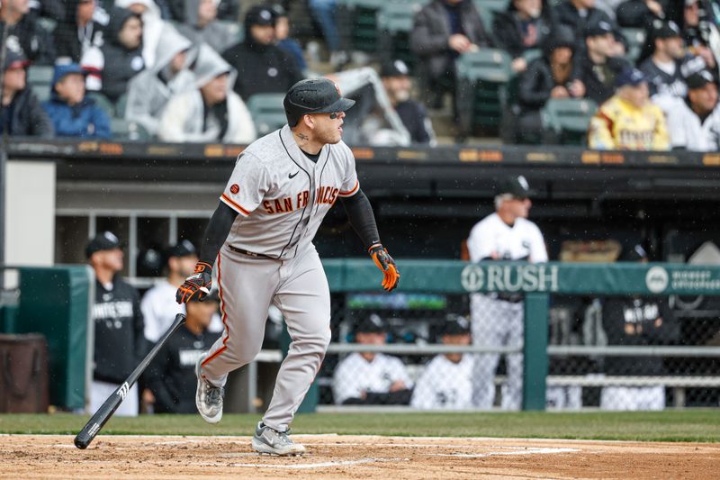 Apr 3, 2023; Chicago, Illinois, USA; San Francisco Giants catcher Roberto Perez (1) watches his RBI-single against the Chicago White Sox during the second inning at Guaranteed Rate Field. Mandatory Credit: Kamil Krzaczynski-USA TODAY Sports