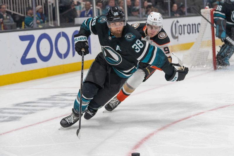 Feb 29, 2024; San Jose, California, USA; San Jose Sharks defenseman Mario Ferraro (38) controls the puck during the third period against Anaheim Ducks center Leo Carlsson (91) at SAP Center at San Jose. Mandatory Credit: Stan Szeto-USA TODAY Sports