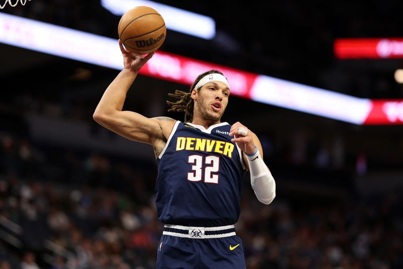 MINNEAPOLIS, MINNESOTA - OCTOBER 17: Aaron Gordon #32 of the Denver Nuggets rebounds the ball against the Minnesota Timberwolves in the first quarter of a preseason game at Target Center on October 17, 2024 in Minneapolis, Minnesota. NOTE TO USER: User expressly acknowledges and agrees that, by downloading and or using this photograph, User is consenting to the terms and conditions of the Getty Images License Agreement. (Photo by David Berding/Getty Images)