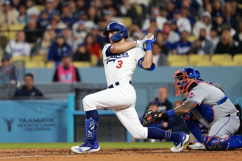 Apr 19, 2024; Los Angeles, California, USA;  Los Angeles Dodgers outfielder Chris Taylor (3) hits an RBI single during the sixth inning against the New York Mets at Dodger Stadium. Mandatory Credit: Kiyoshi Mio-USA TODAY Sports