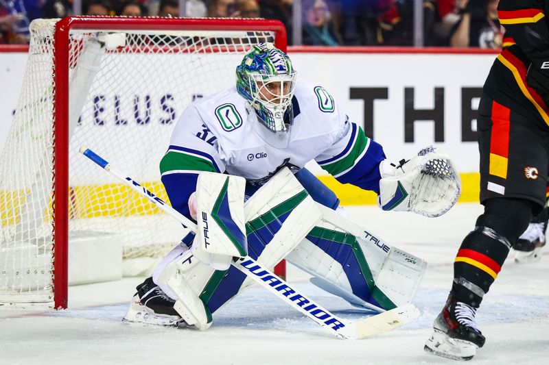 Dec 31, 2024; Calgary, Alberta, CAN; Vancouver Canucks goaltender Kevin Lankinen (32) guards his net against the Calgary Flames during the second period at Scotiabank Saddledome. Mandatory Credit: Sergei Belski-Imagn Images