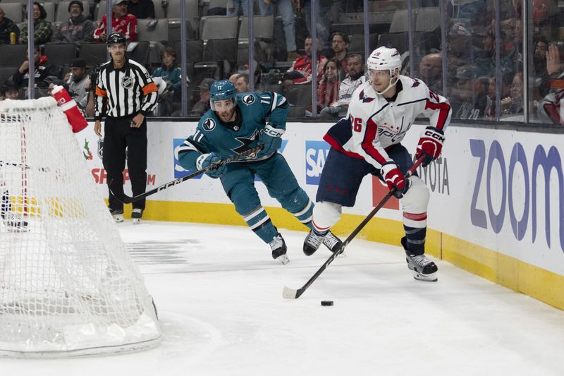 Nov 27, 2023; San Jose, California, USA; Washington Capitals right wing Nic Dowd (26) skates with the puck against San Jose Sharks center Luke Kunin (11) during the second period at SAP Center at San Jose. Mandatory Credit: Neville E. Guard-USA TODAY Sports