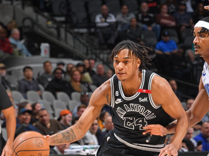 SAN ANTONIO, TX - MARCH 14: Devin Vassell #24 of the San Antonio Spurs dribbles the ball during the game against the Orlando Magic on March 14, 2023 at the AT&T Center in San Antonio, Texas. NOTE TO USER: User expressly acknowledges and agrees that, by downloading and or using this photograph, user is consenting to the terms and conditions of the Getty Images License Agreement. Mandatory Copyright Notice: Copyright 2023 NBAE (Photos by Michael Gonzales/NBAE via Getty Images)